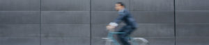 Unsharp, blurry image of a business man on his bike